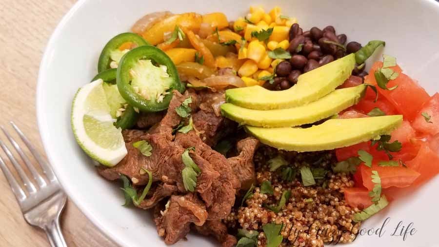 burrito bowl in a white bowl with toppings