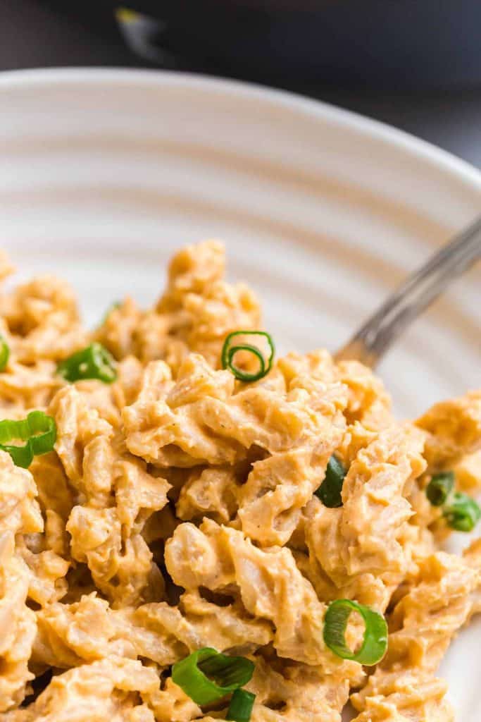 close up of pasta covered in buffalo sauce