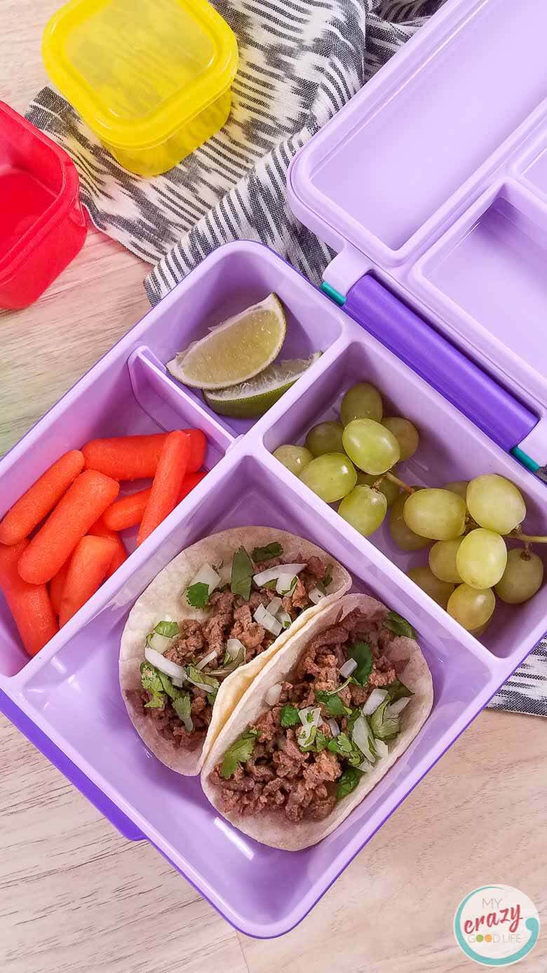 image of carne asada street tacos in a lunch bento box with fruit and vegetables