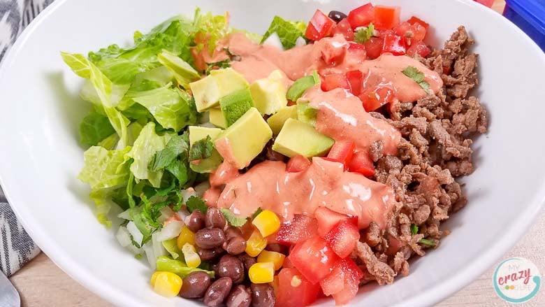 This Carne Asada Burrito Bowl includes a recipe for Homemade Creamy Chili Lime Dressing that's going to be your next favorite healthy dressing recipe! Citrus-seasoned Carne Asada and delicious vegetables and black beans make a delicious Mexican dinner for your Carne Asada leftovers!