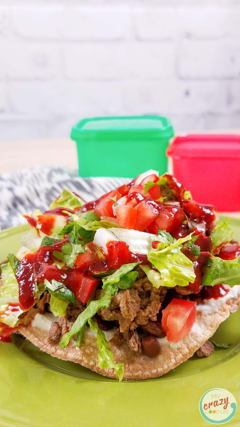 Carne Asada Tostada on a green plate, made with leftover carne asada