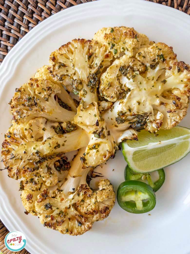 image of single cauliflower steak on a white plate