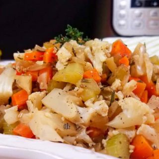 This low carb Cauliflower Stuffing can be made in the Instant Pot or in the oven, and is the perfect Thanksgiving side dish! All of the delicious stuffing flavors with less carbs and calories than your traditional stuffing recipe–that means I can eat more! Vegan Stuffing Recipe | Low-Carb Stuffing Recipe | Holiday Side Dish | Roasted Cauliflower Rice Stuffing | Healthy Cauliflower Rice Recipes #stuffing #thanksgiving #healthy