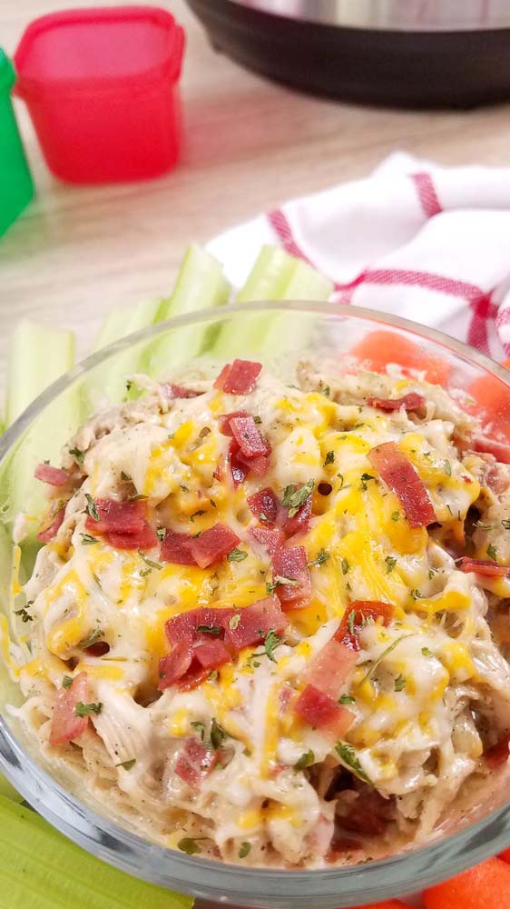 close up on crack chicken dip in a glass bowl