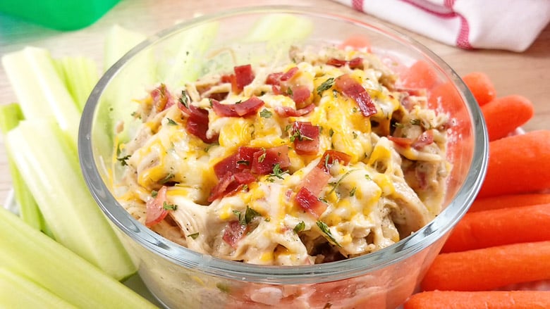 crack chicken in clear bowl with vegetables