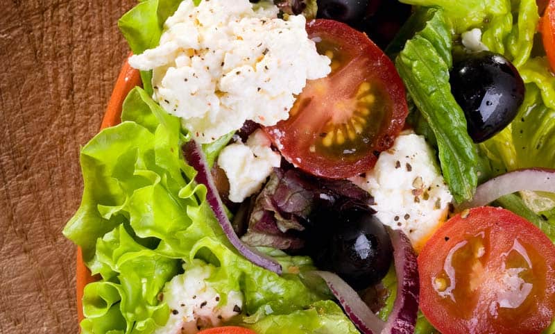 close up of salad in a red bowl