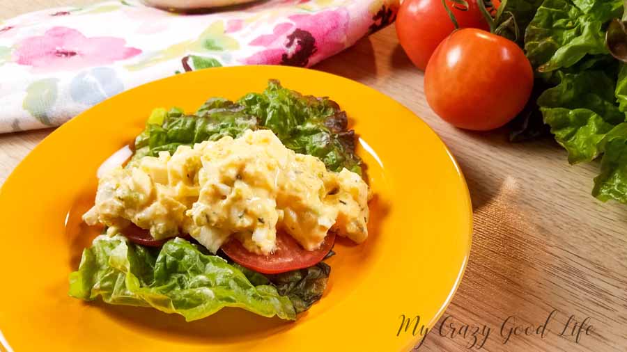 egg salad on a bed of lettuce on a yellow plate