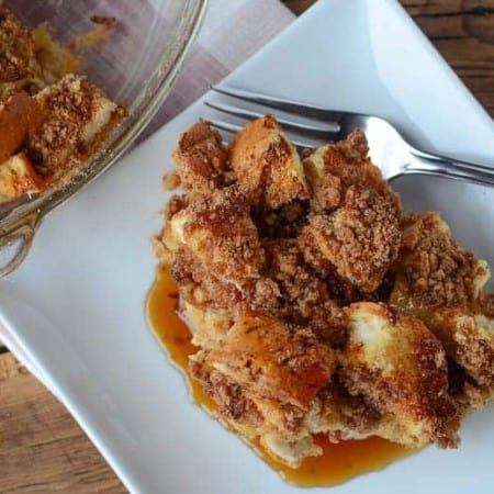 square white plate with dinner roll french toast casserole and fork