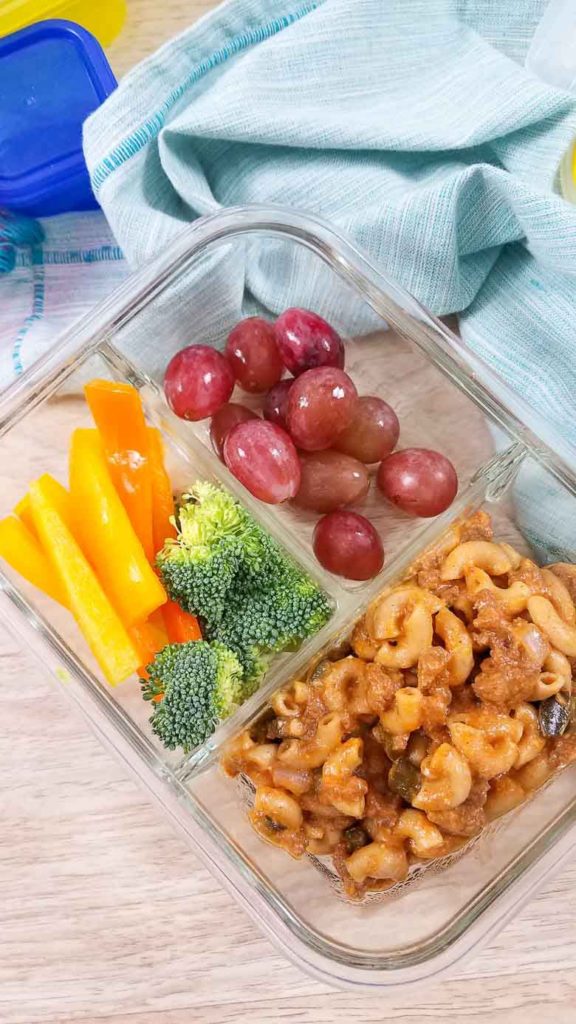 glass meal prep container with veggies, fruit, and hamburger helper