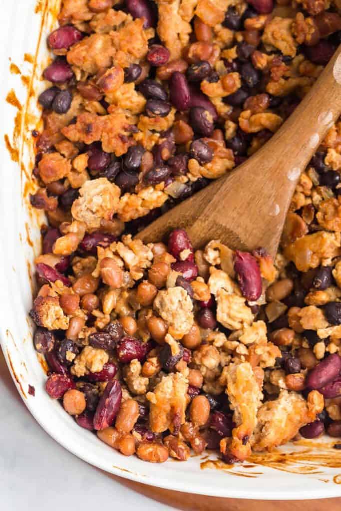 close up of a white dish with cooked healthy baked beans