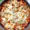 top down image of whole lasagna in a pan on a wood table