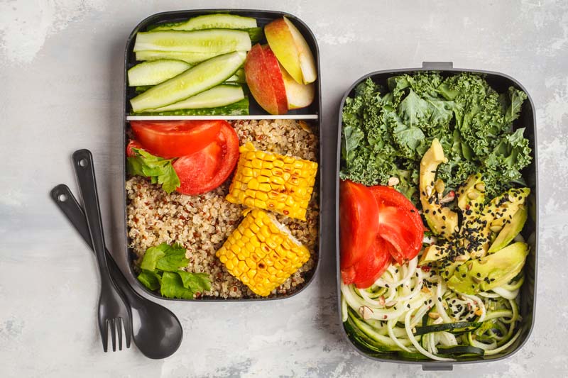 two meal prep containers with utensils