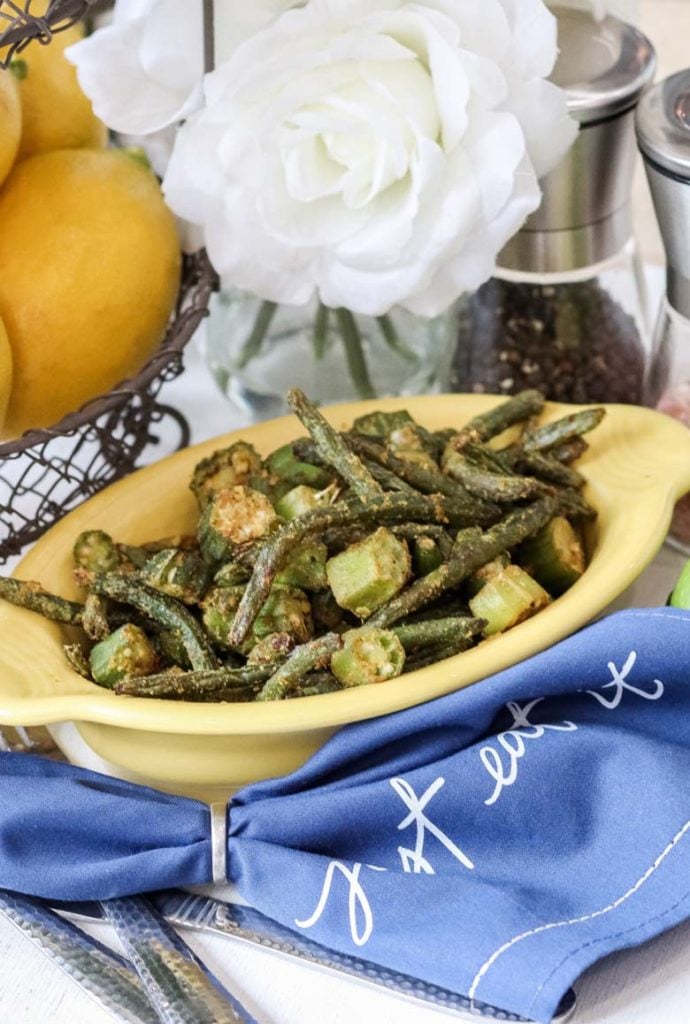 air fryer okra and green beans in a yellow bowl on top of a blue napkin