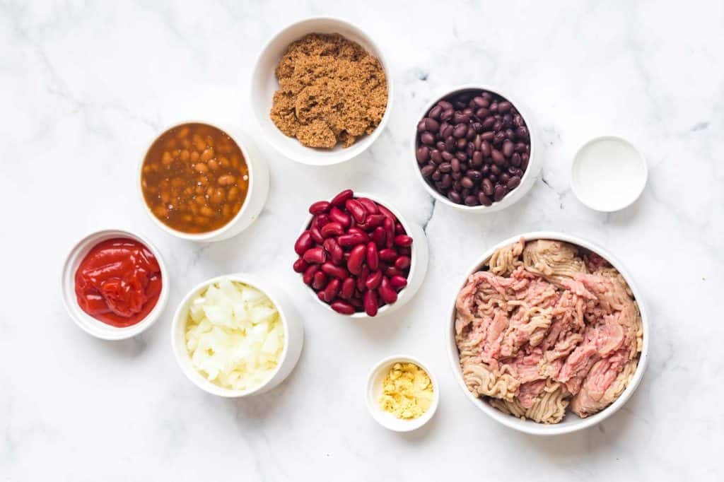 white bowls of ingredients on a white countertop