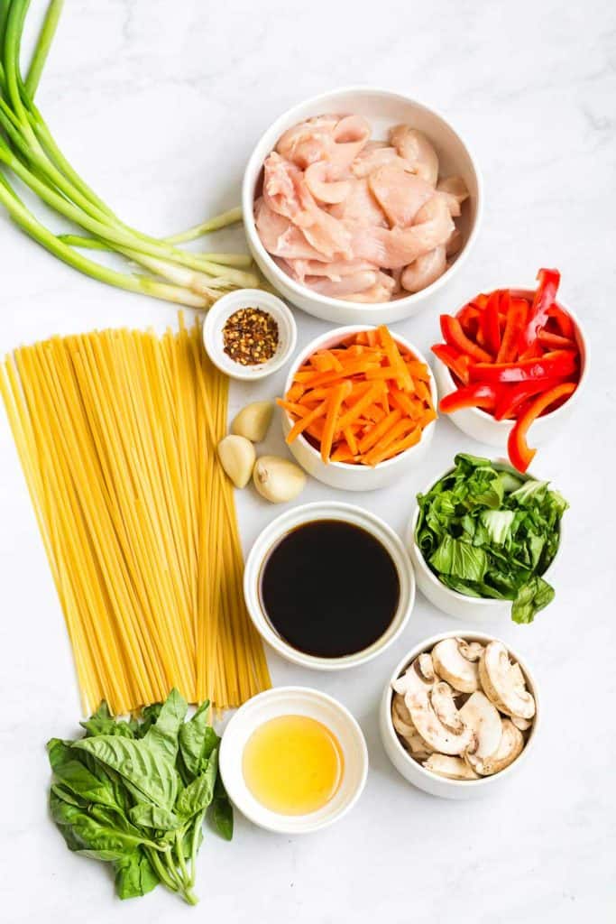 top down shot of ingredients for this recipe in white bowls except pasta, which is placed on the counter.