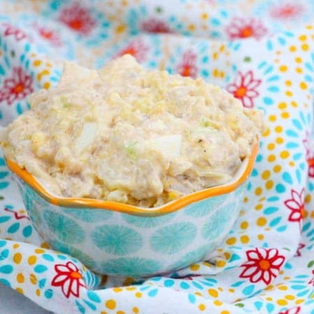 bowl of instant pot cauliflower potato salad on a blue flowered napkin