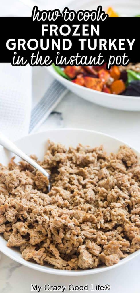 cooked ground turkey in white bowl with salad in background