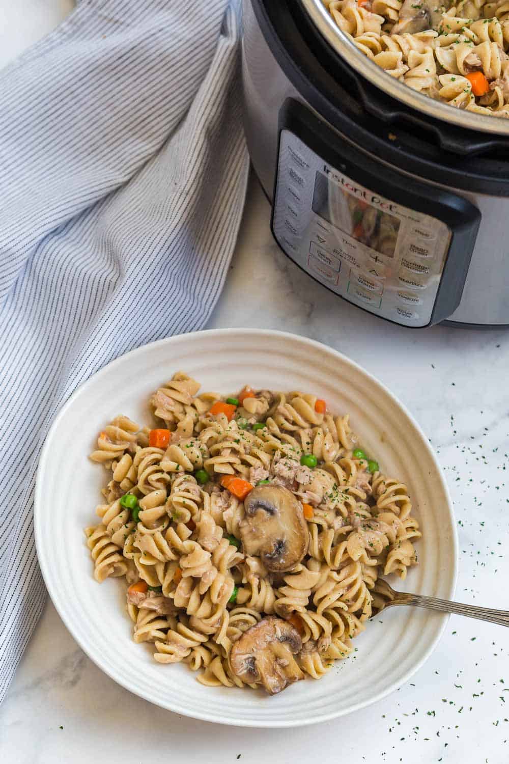 healthy tuna casserole in white bowl next to instant pot