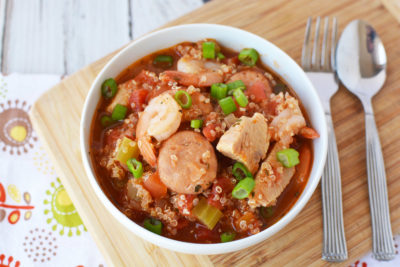 jambalaya in a white bowl on a wood table