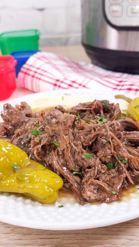 vertical image of pot roast with red and white napkin