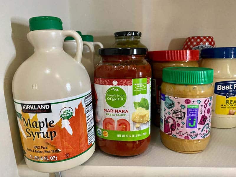 pantry items syrup, nut butters, and pasta sauce