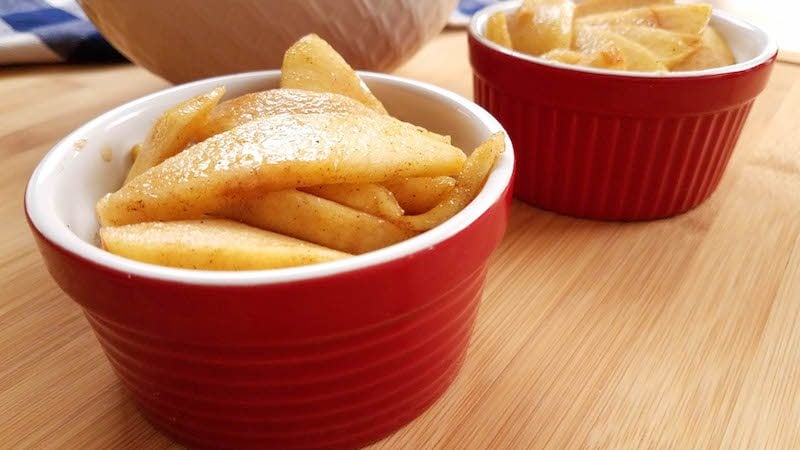 Small red container of pumpkin spiced apples for serving and eating. 