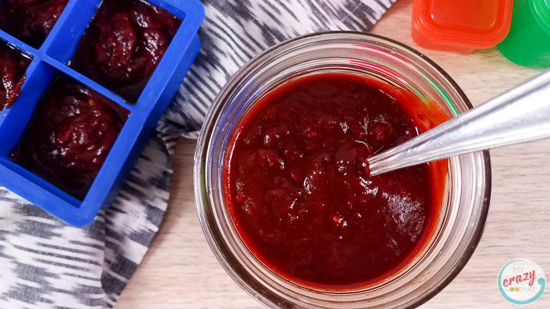 Image with red enchilada sauce in a glass container.