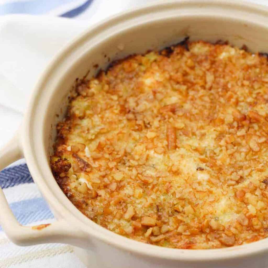 Hot Artichoke Dip Recipe in a cream colored baking dish