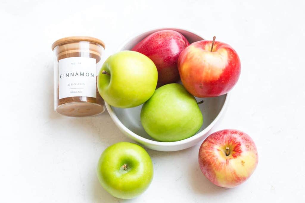 image of bowl of apples and a jar of cinnamon