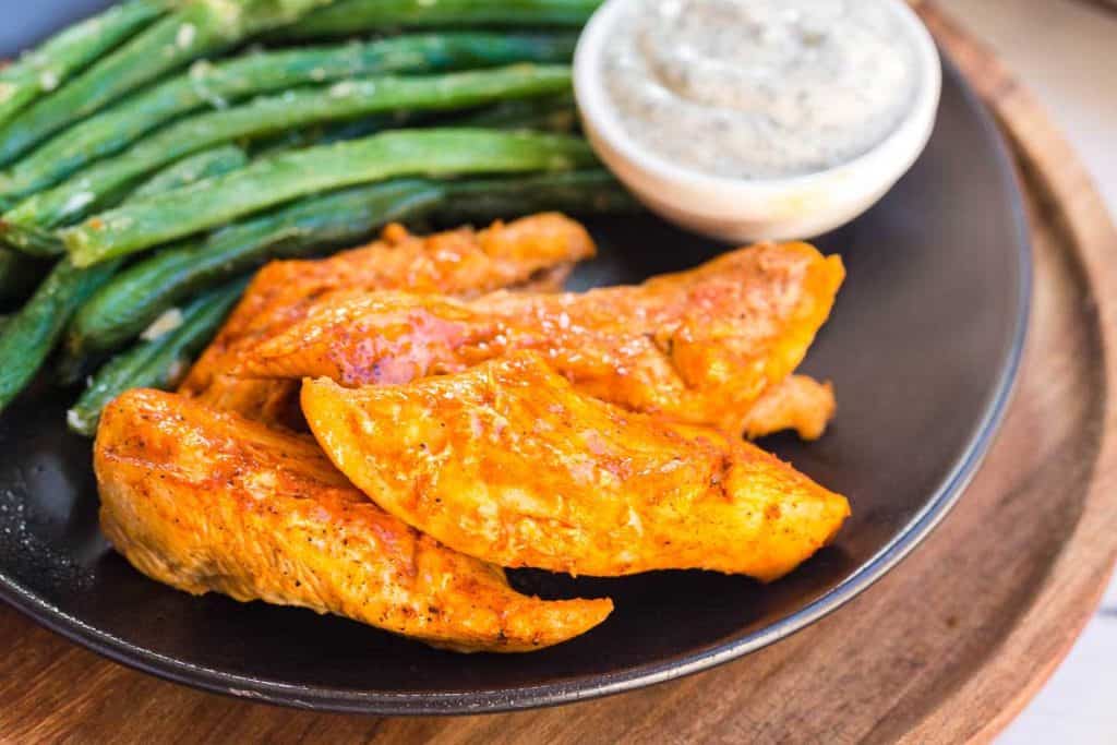 plate with Instant Pot Buffalo Chicken Bites, ranch dip, and asparagus