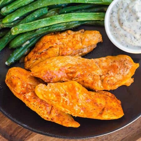 plate with Instant Pot Buffalo Chicken Bites, ranch dip, and asparagus