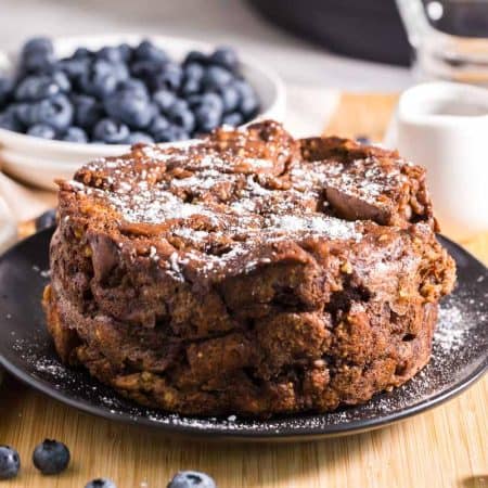 Healthy French Toast Casserole with powdered sugar on top and blueberries in the background