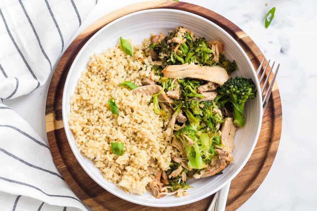 Instant Pot Honey Garlic Chicken in a white bowl on top of a wooden platter