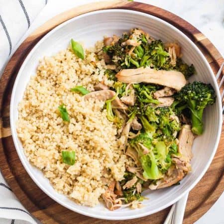 Instant Pot Honey Garlic Chicken in a white bowl on top of a wooden platter