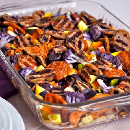 casserole dish with veggies and grilled sausage