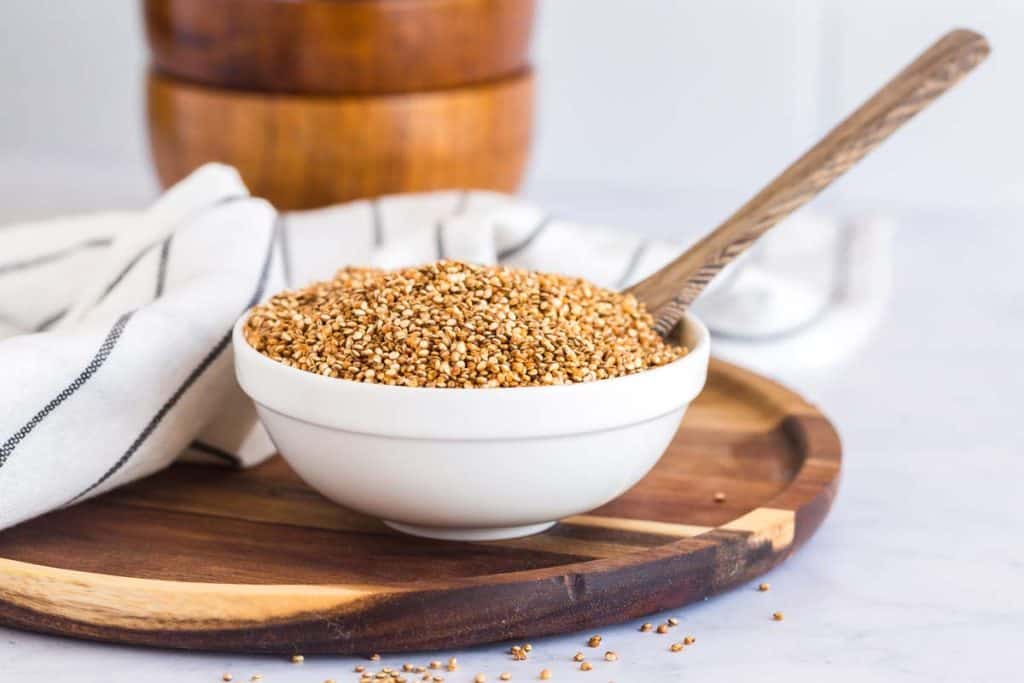 bowl of crispy quinoa on a wooden plate