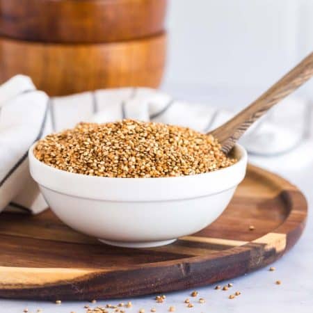 bowl of crispy quinoa on a wooden plate