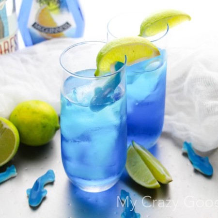 There's nothing better than curling up on the couch and enjoying Shark Week with a drink! This fun Shark Bite Margarita is the perfect Shark Week companion! Be careful... this one is strong, and it bites back! Shark Week Cocktails | Blue Margarita | Shark Week Margarita