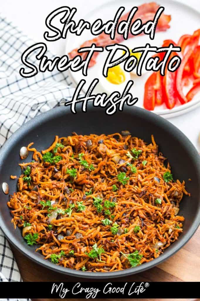 black pan with cooked sweet potato hash browns and onions with decorative parsley on top. In the background is a wood tray, blue and white napkin, and a white plate with hard boiled eggs, bacon, and sliced red peppers. There is text on this picture. 