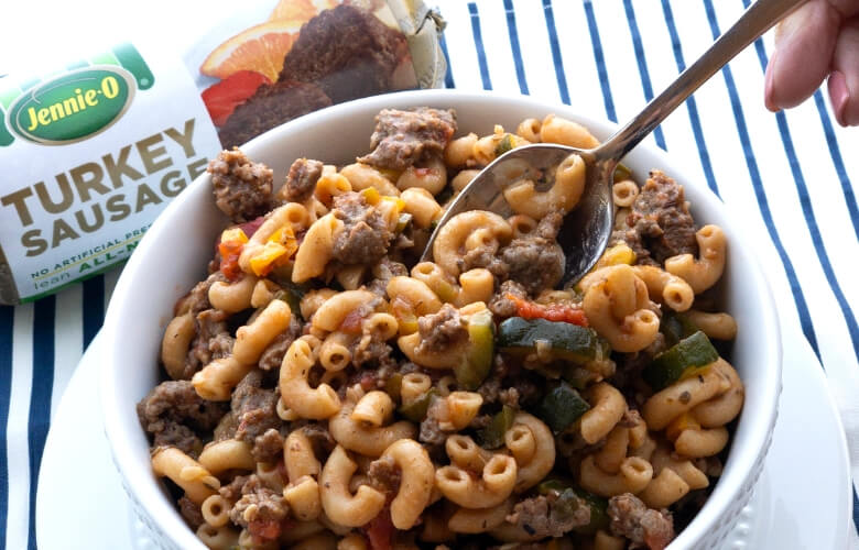 goulash in a white bowl with a spoon in it