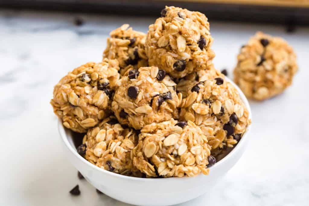 white bowl with ready to eat protein balls stacked inside.